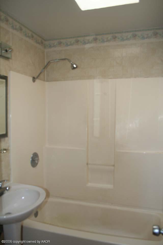 4365 South Tyler Street Amarillo, TX 79110 - Photo 6 of 6 a bathroom with a shower and a sink