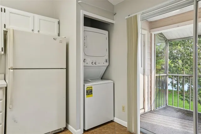 a utility room with wooden floor washer and dryer