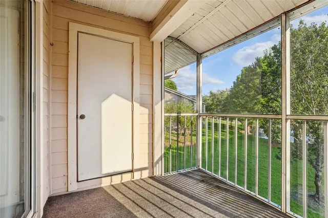a view of a balcony with floor to ceiling windows