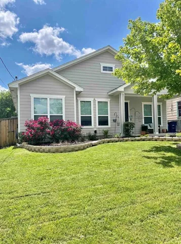 a front view of house with yard and green space