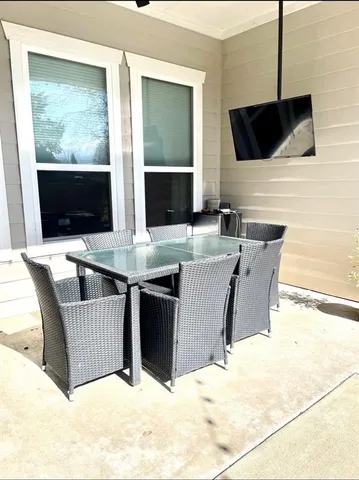 a living room with furniture window and a flat screen tv