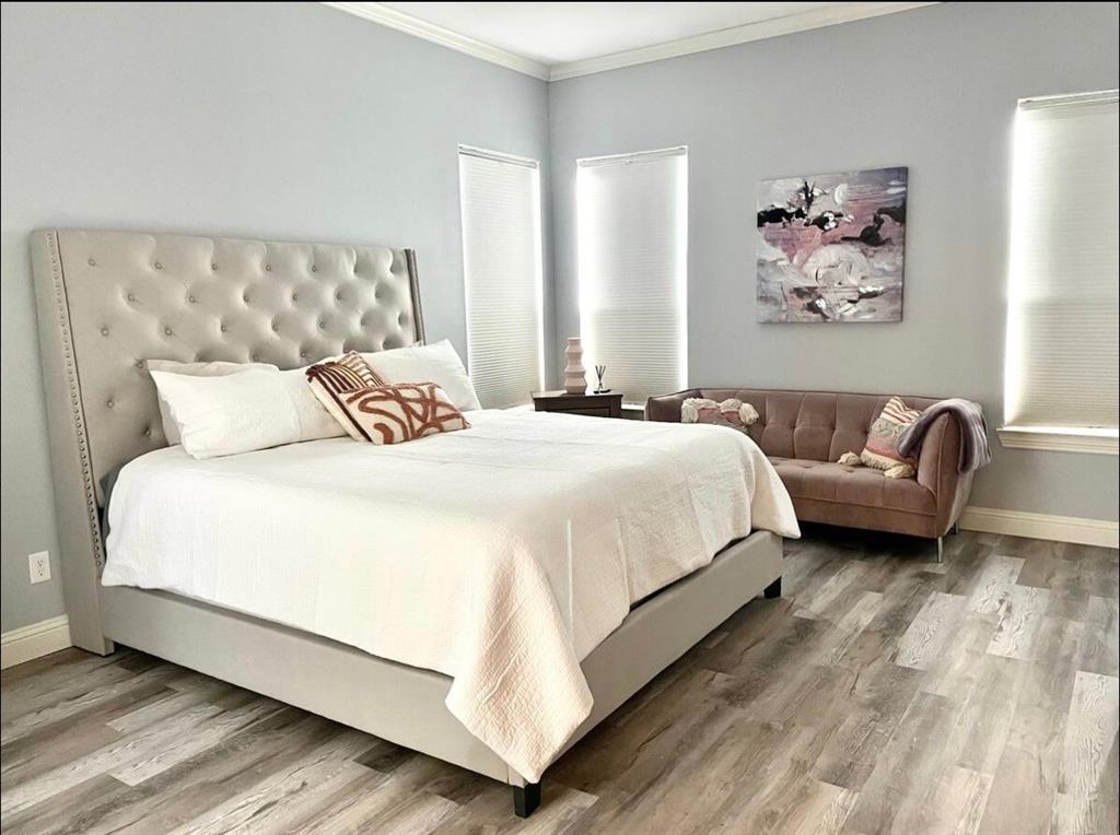 3526 Ivandell Avenue Dallas, TX 75211 - Photo 13 of 17 a bedroom with bed and a couch