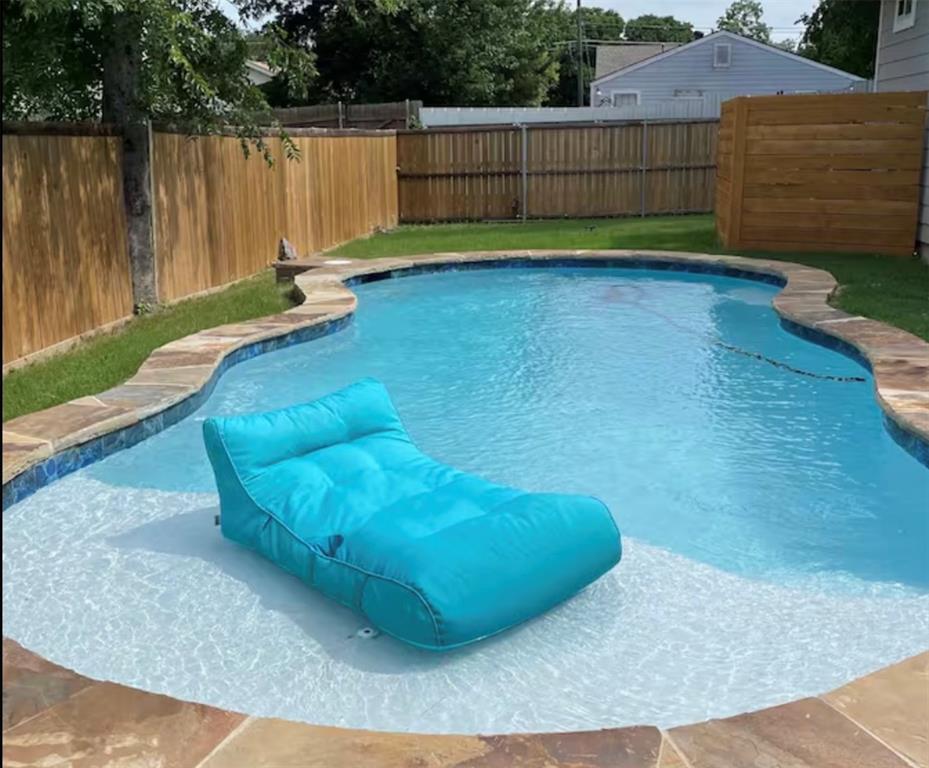 3526 Ivandell Avenue Dallas, TX 75211 - Photo 15 of 17 a view of a backyard with wooden fence