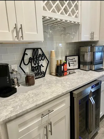 a kitchen with granite countertop a sink a stove and cabinets