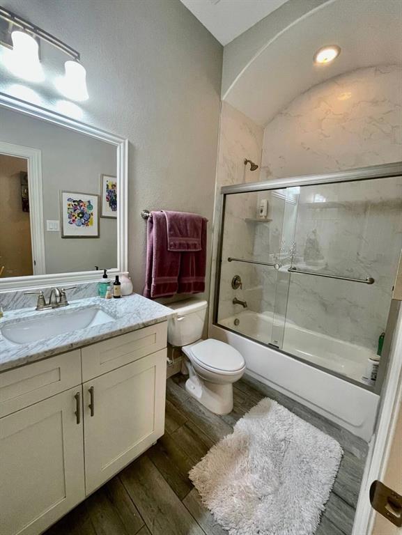 3526 Ivandell Avenue Dallas, TX 75211 - Photo 8 of 17 a bathroom with a granite countertop sink toilet and shower