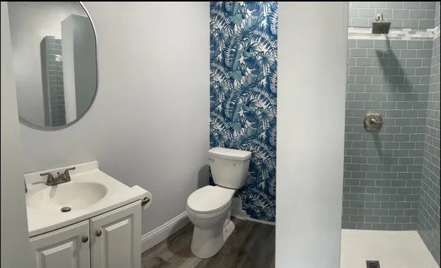 a bathroom with a toilet sink and mirror