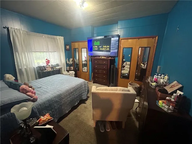 a bed room with furniture and window