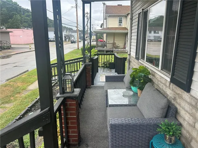 a view of balcony with furniture