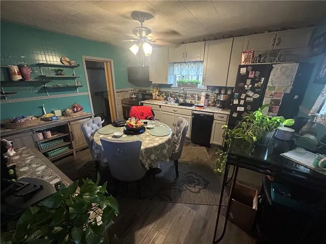 a view of a dining room with furniture and a chandelier