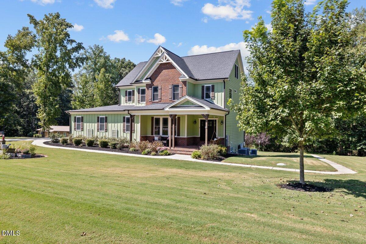 a front view of a house with swimming pool having outdoor seating