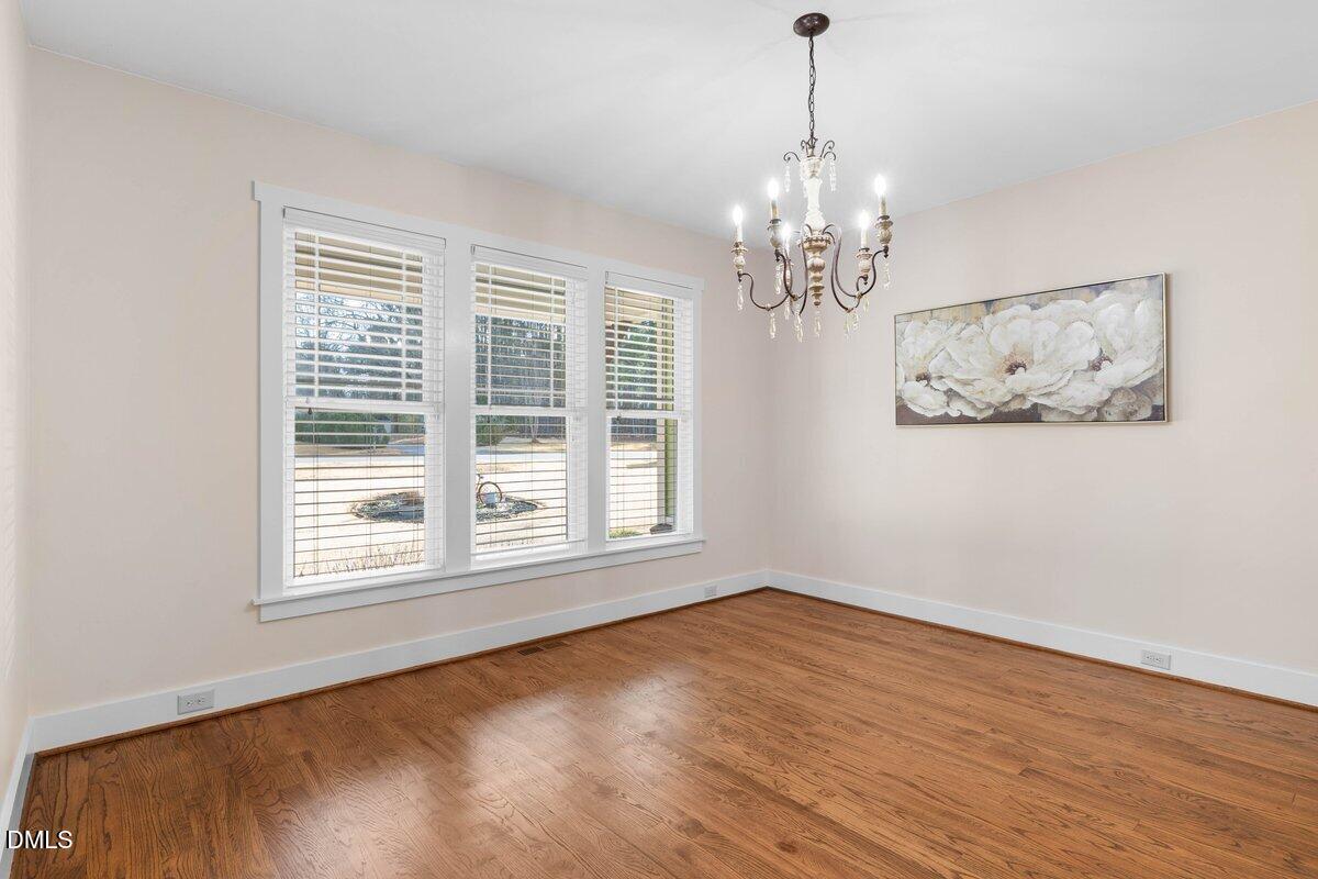 1616 Bowling Road Fuquay-Varina, NC 27526 - Photo 8 of 33 a view of a room with wooden floor chandelier and windows