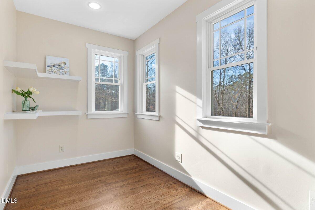 1616 Bowling Road Fuquay-Varina, NC 27526 - Photo 9 of 33 a view of a bedroom with wooden floor and a window