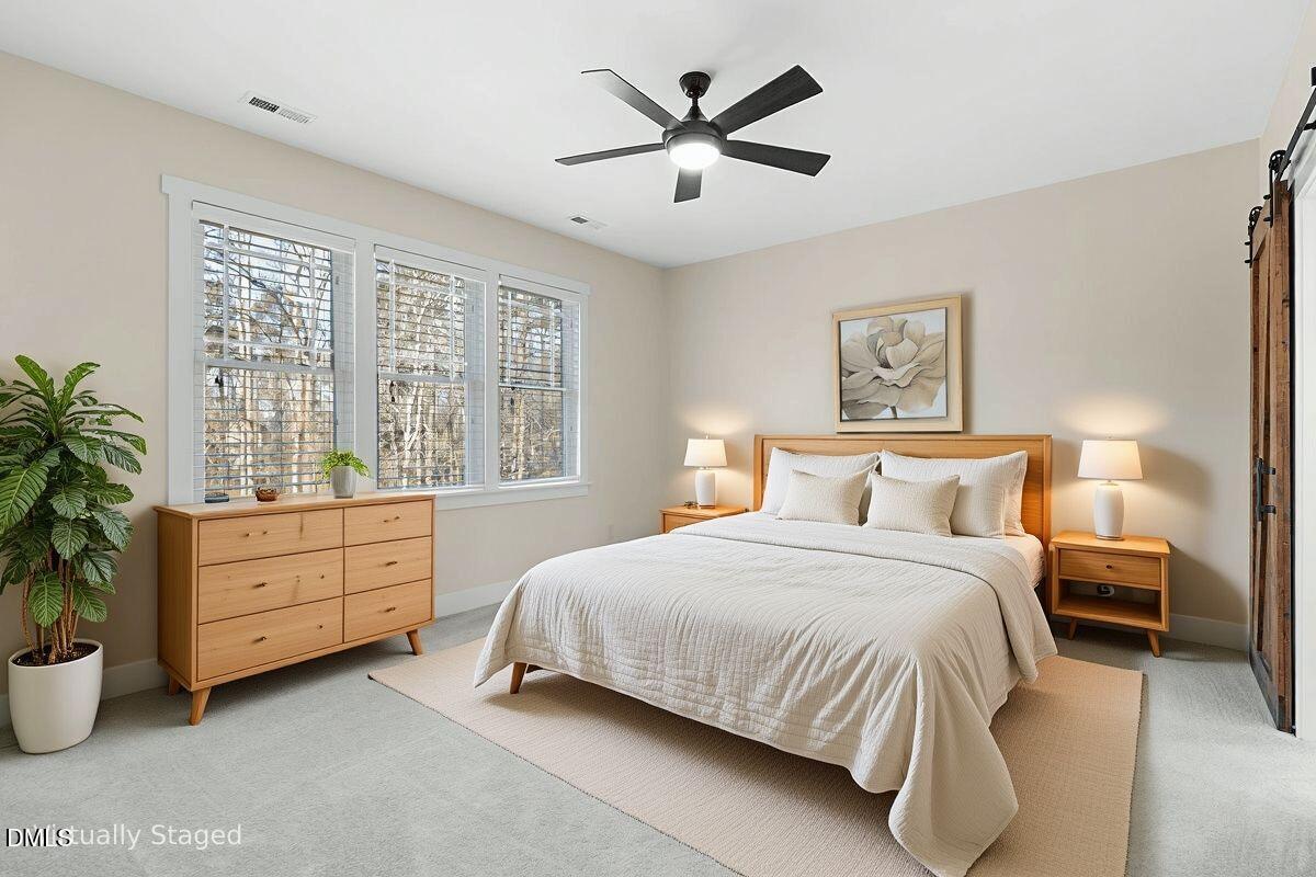 1616 Bowling Road Fuquay-Varina, NC 27526 - Photo 12 of 33 a bedroom with a bed and a large window