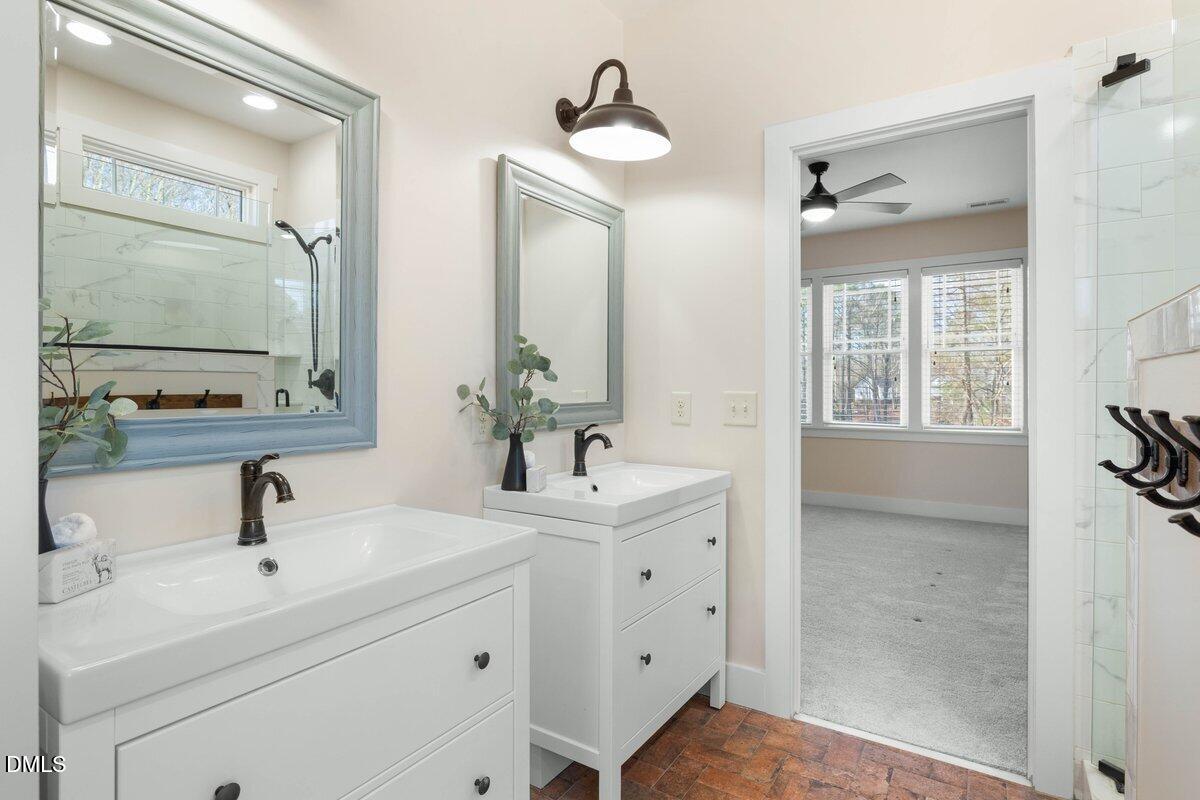 1616 Bowling Road Fuquay-Varina, NC 27526 - Photo 15 of 33 a bathroom with a sink a toilet and mirror