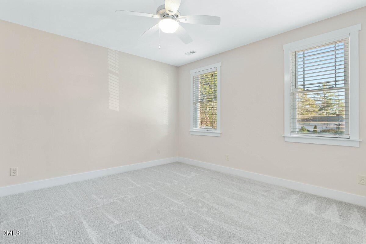 1616 Bowling Road Fuquay-Varina, NC 27526 - Photo 16 of 33 an empty room with windows and fan