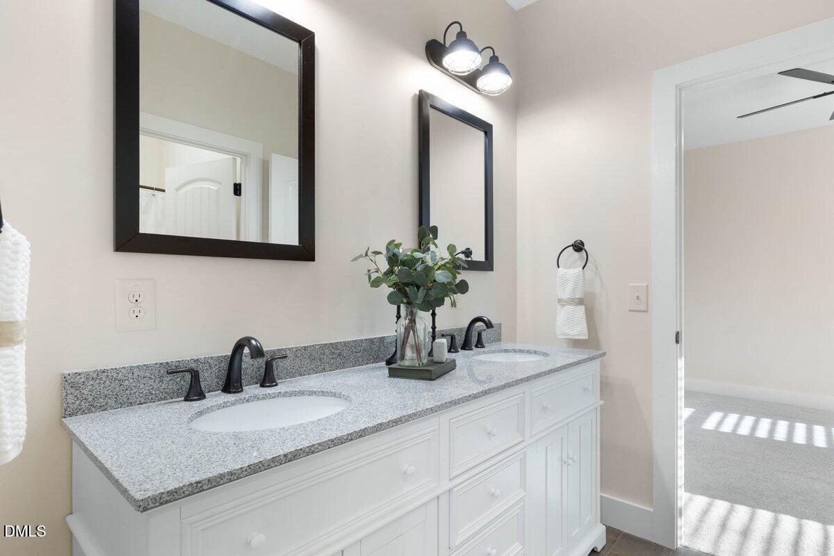 1616 Bowling Road Fuquay-Varina, NC 27526 - Photo 17 of 33 a bathroom with sink and mirror