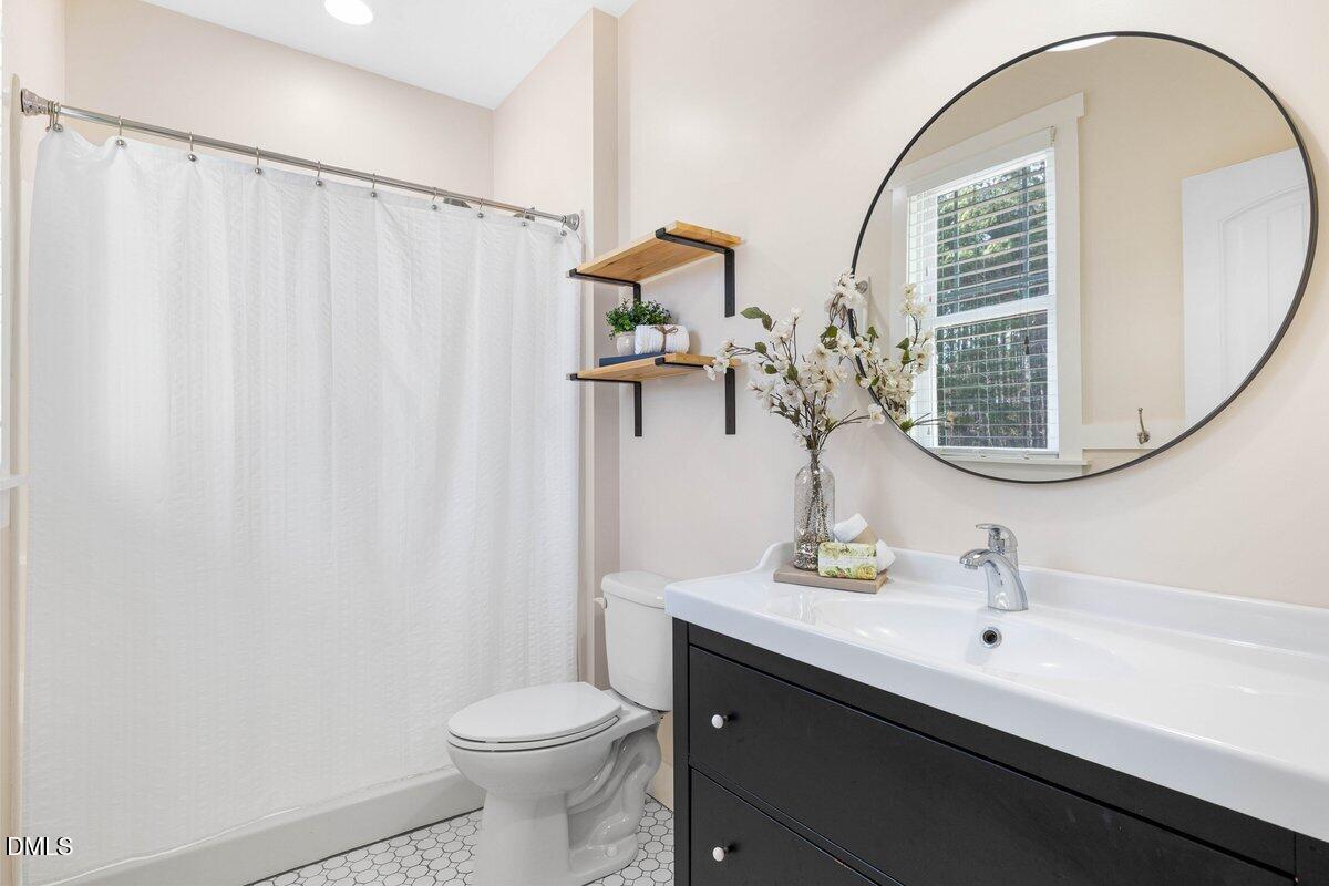 1616 Bowling Road Fuquay-Varina, NC 27526 - Photo 19 of 33 a bathroom with a sink vanity mirror and toilet