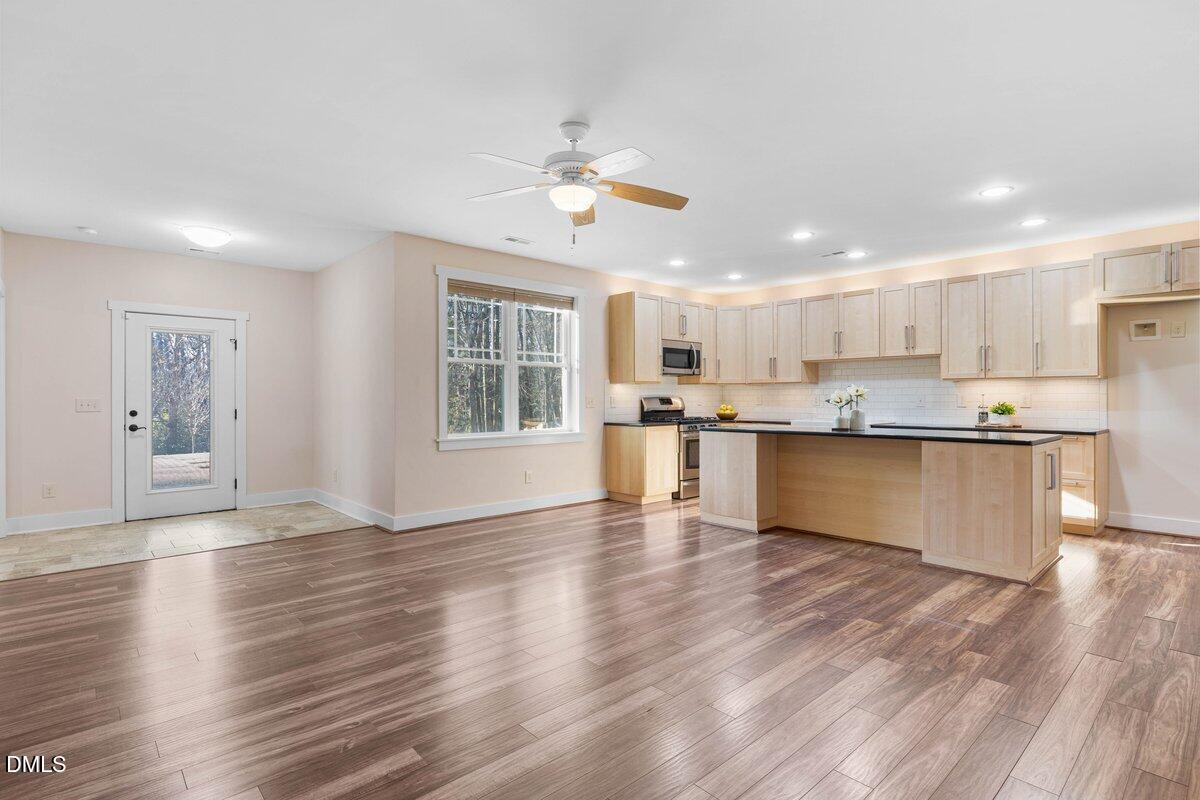 1616 Bowling Road Fuquay-Varina, NC 27526 - Photo 21 of 33 a view of kitchen with wooden floor and window