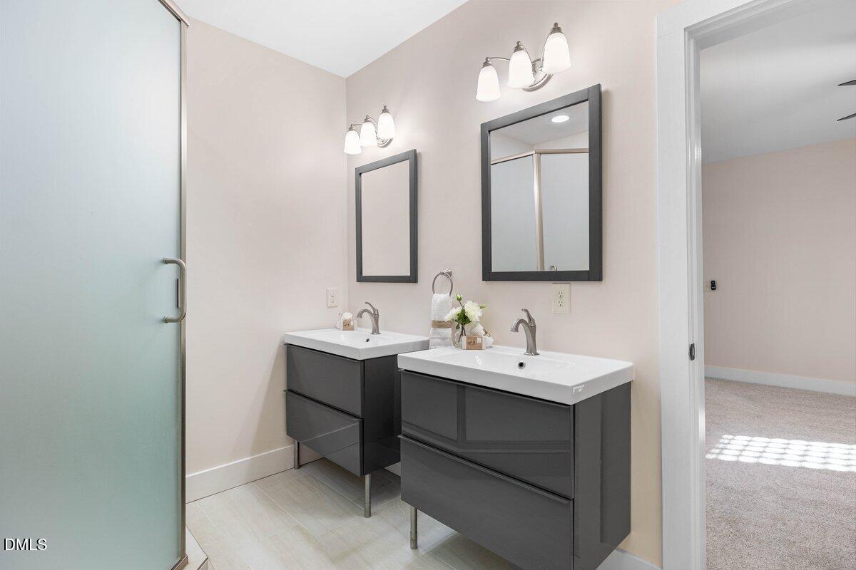 1616 Bowling Road Fuquay-Varina, NC 27526 - Photo 25 of 33 a bathroom with a toilet sink and mirror
