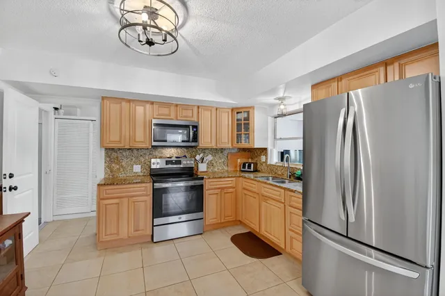 a kitchen with a refrigerator stove and microwave