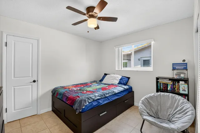 a bedroom with a bed and flat screen tv