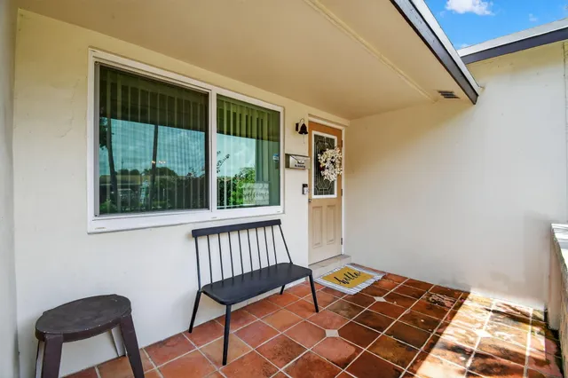 a view of a room with furniture and a window
