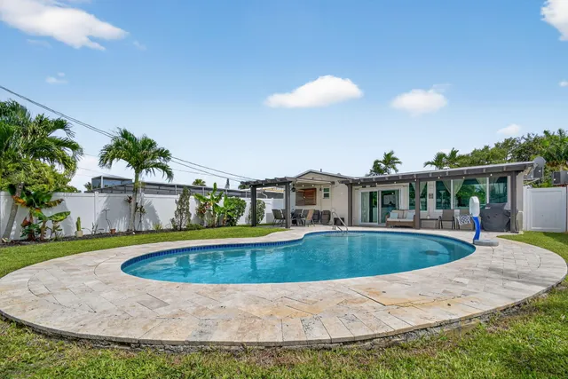 an aerial view of a house with a swimming pool yard and outdoor seating
