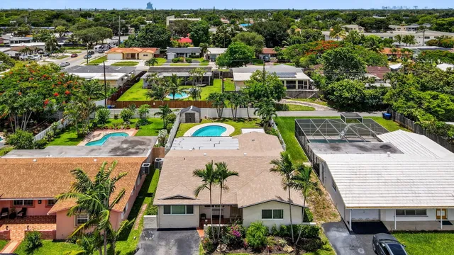 an aerial view of residential houses with outdoor space and street view