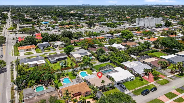 an aerial view of residential house with outdoor space and swimming pool