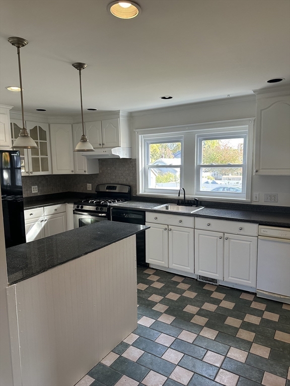 36 Jasper Street Saugus, MA 01906 - Photo 11 of 39 a kitchen with stainless steel appliances granite countertop a sink a stove and a granite counter tops