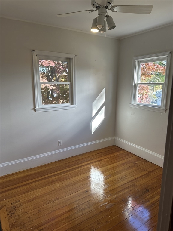 36 Jasper Street Saugus, MA 01906 - Photo 23 of 39 a view of an empty room with window and wooden floor