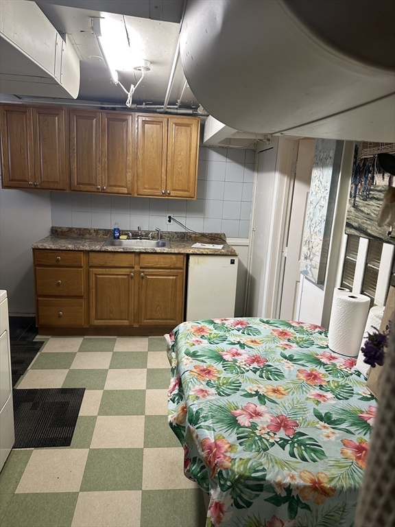 36 Jasper Street Saugus, MA 01906 - Photo 34 of 39 a kitchen with kitchen island a stove a sink and a refrigerator