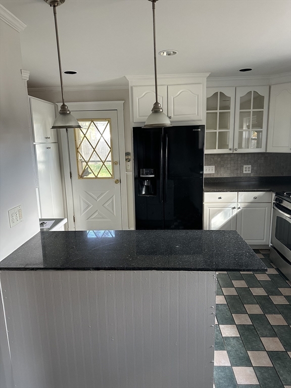 36 Jasper Street Saugus, MA 01906 - Photo 10 of 39 a kitchen with a refrigerator and a stove
