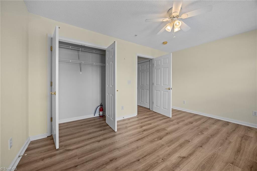 5001 Bass Chapel Road, Unit 3D Greensboro, NC 27455 - Photo 37 of 50 Freshly painted second bedroom with ample closet storage.