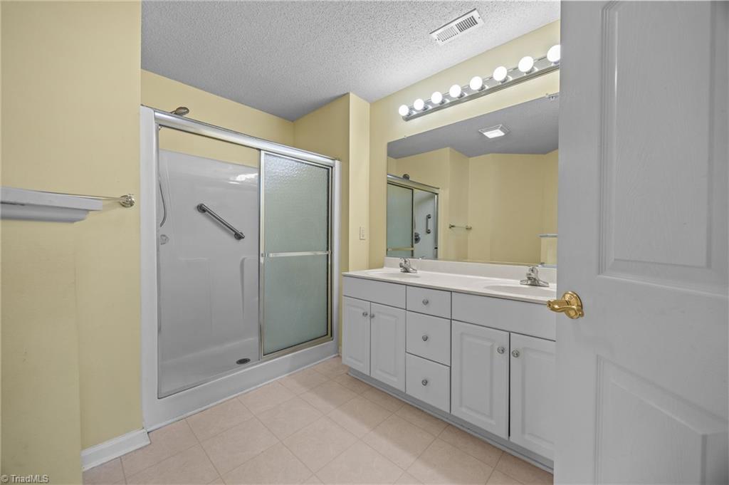 5001 Bass Chapel Road, Unit 3D Greensboro, NC 27455 - Photo 38 of 50 Another separate full bathroom with double vanity and shower and tub combo.