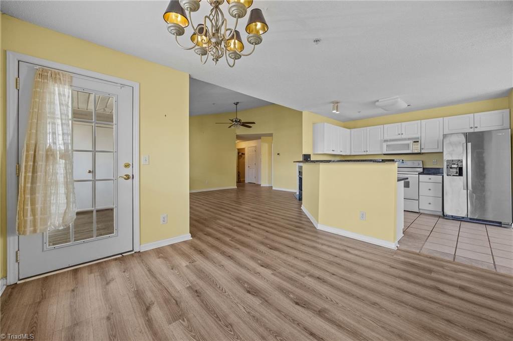 5001 Bass Chapel Road, Unit 3D Greensboro, NC 27455 - Photo 44 of 50 Freshly painted spacious living room with view of the kitchen.