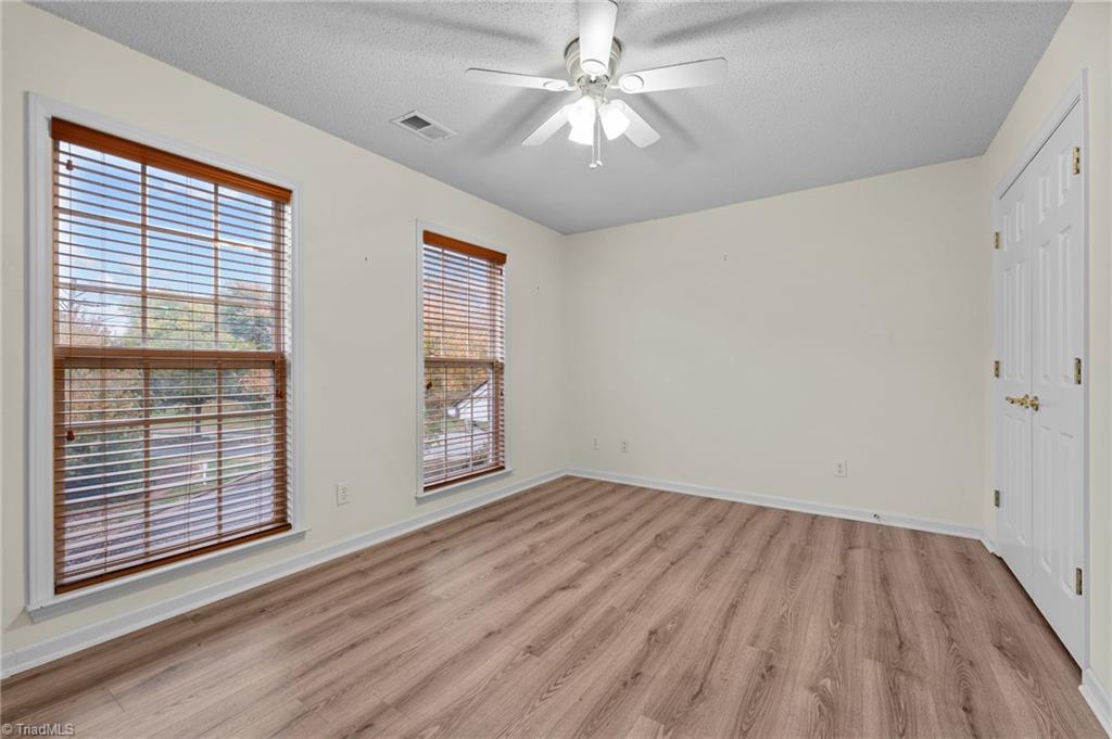 5001 Bass Chapel Road, Unit 3D Greensboro, NC 27455 - Photo 8 of 50 Second bedroom with ceiling fan and plenty of natural light.