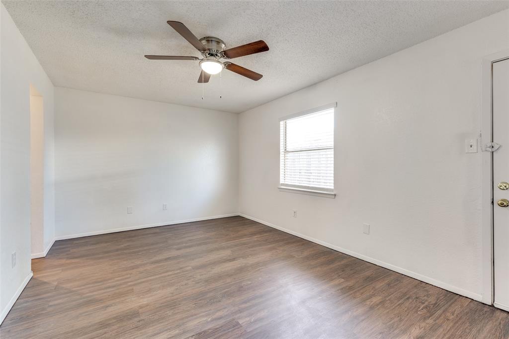 3624 Hulen Park Circle Fort Worth, TX 76123 - Photo 2 of 12 an empty room with wooden floor fan and windows