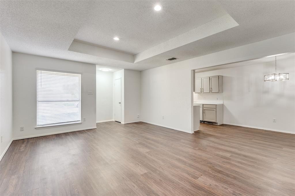 3624 Hulen Park Circle Fort Worth, TX 76123 - Photo 5 of 12 an empty room with wooden floor cabinet and windows