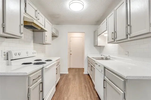 a kitchen with stainless steel appliances granite countertop a stove and a sink