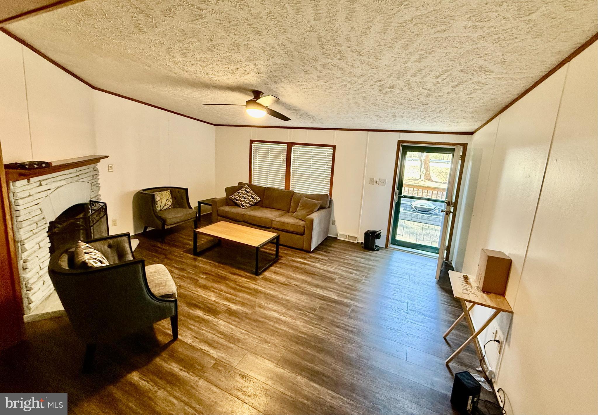 17858 Piney Point Road Tall Timbers, MD 20690 - Photo 2 of 4 a living room with furniture and a flat screen tv