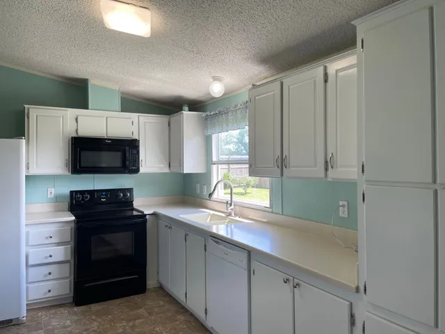a kitchen with a sink and a stove top oven