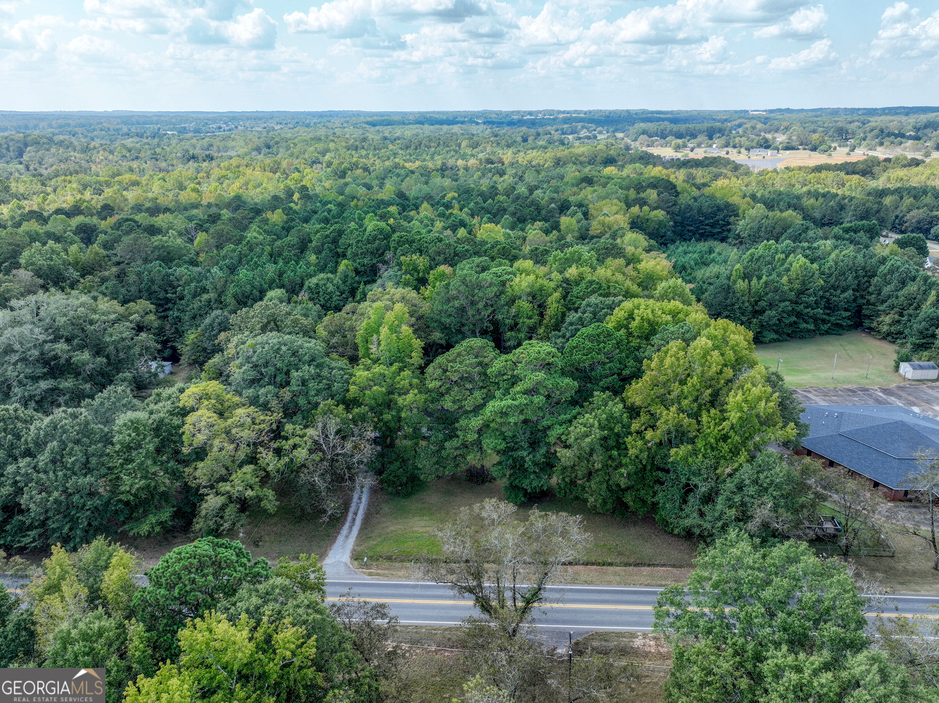 1541 Zebulon Road, Unit 4 TRACTS 35 ACRES Griffin, GA 30224 - Photo 22 of 26 an aerial view of a house with yard
