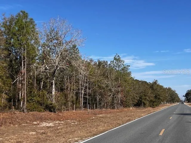 a view of a road with a building in the background