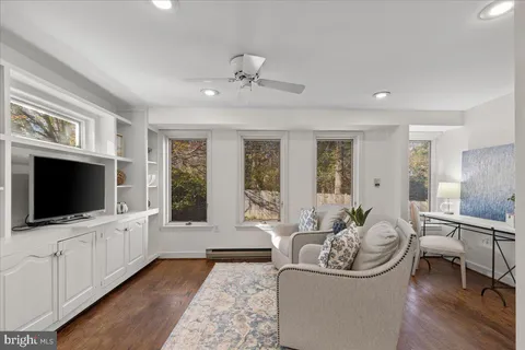 a view of a dining room with furniture a chandelier and wooden floor