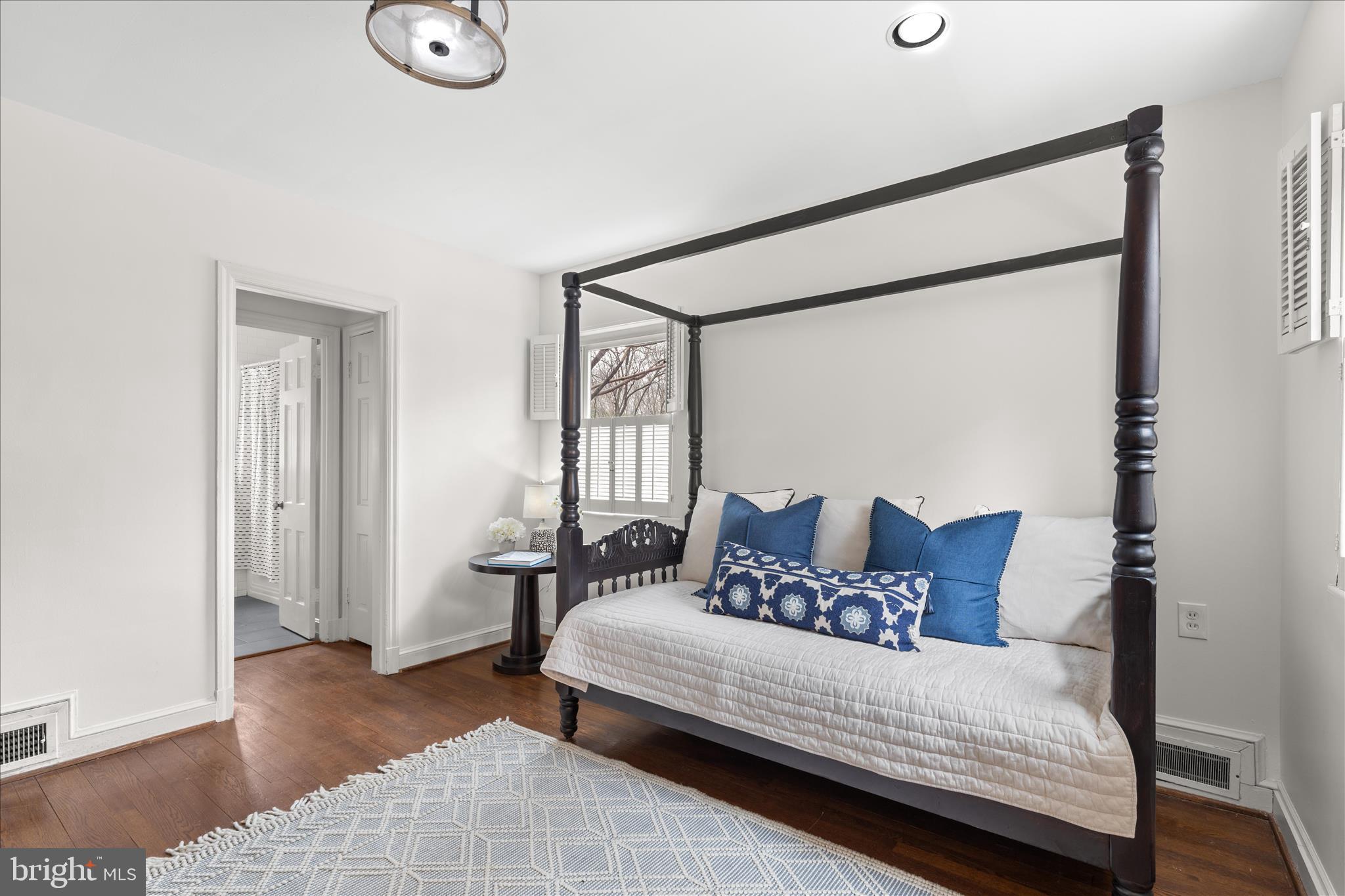 5352 29th Street Northwest Washington, DC 20015 - Photo 18 of 45 a bedroom with a bed and wooden floor