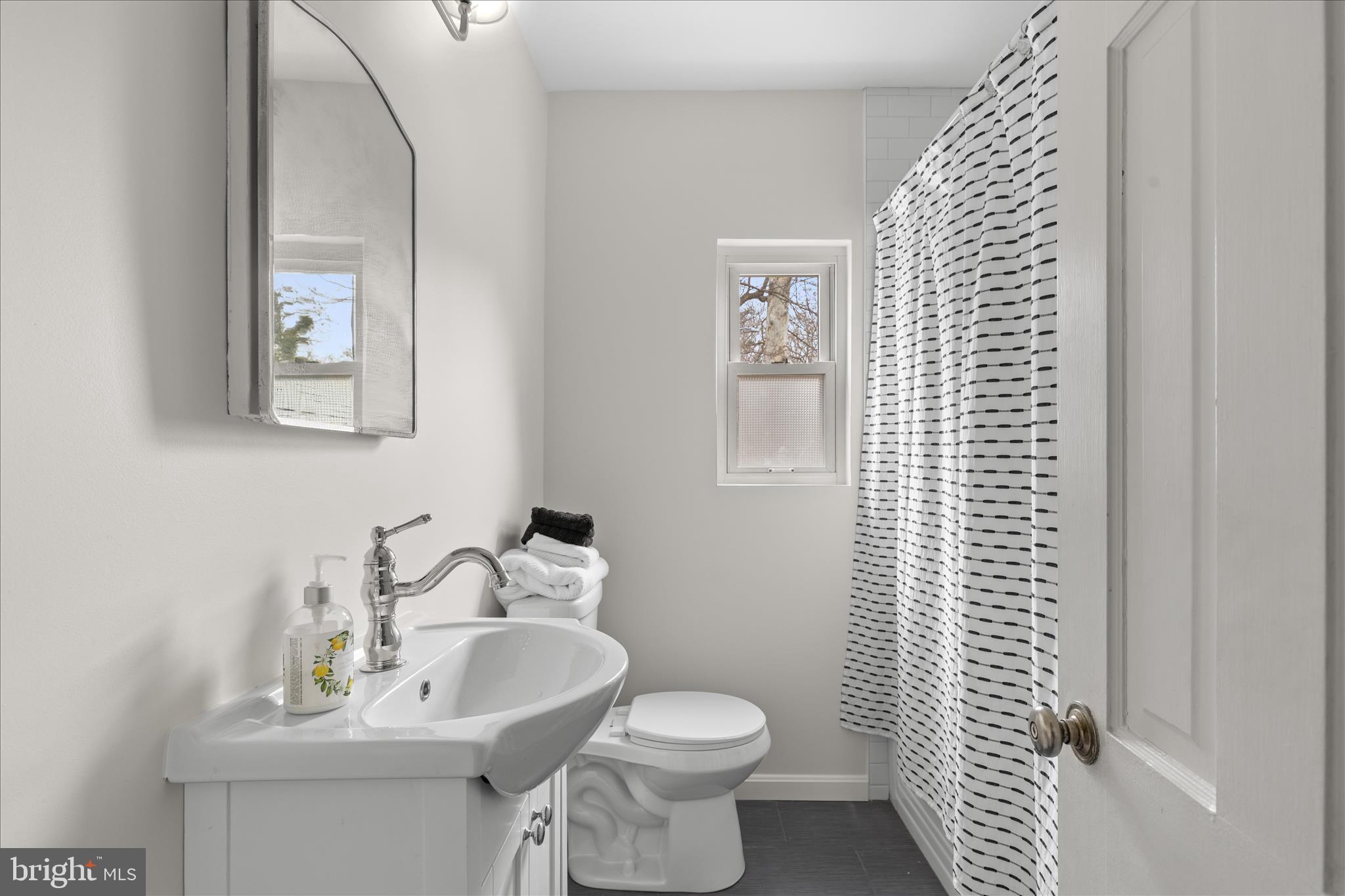 5352 29th Street Northwest Washington, DC 20015 - Photo 21 of 45 a bathroom with a sink toilet and mirror