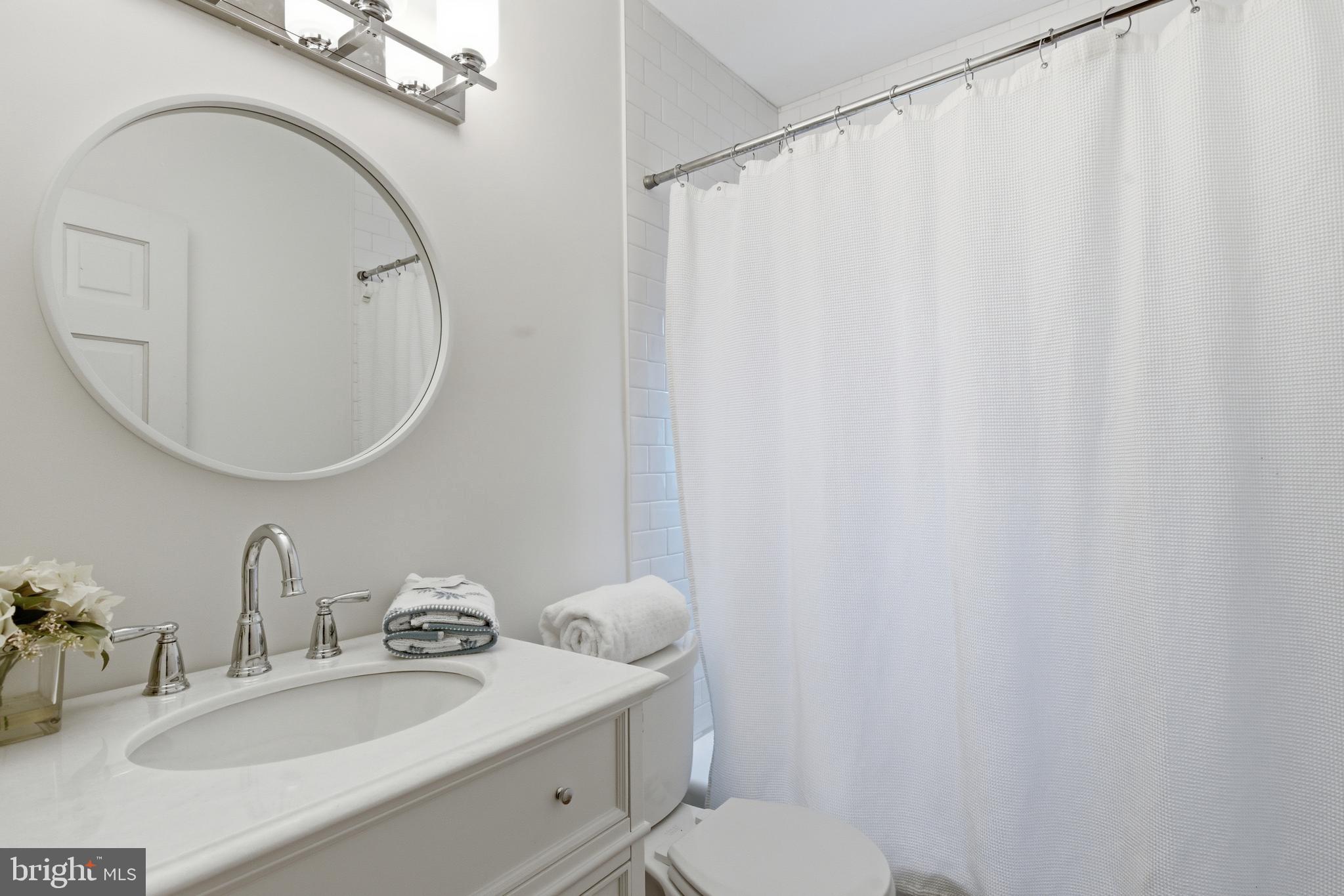 5352 29th Street Northwest Washington, DC 20015 - Photo 27 of 45 a bathroom with a sink toilet and a mirror