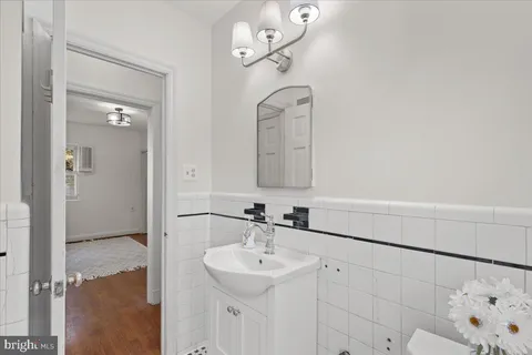 a bathroom with a sink a toilet and a mirror