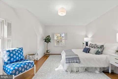 a living room with furniture wooden floor and a lamp